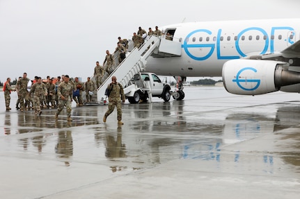 Approximately 100 Alaska Army National Guardsmen assigned to Bravo Company, 1st Battalion, 297th Infantry Regiment, arrive at Joint Base Elmendorf-Richardson, Alaska, Aug. 10, 2024, after a nine-month deployment to Kuwait.