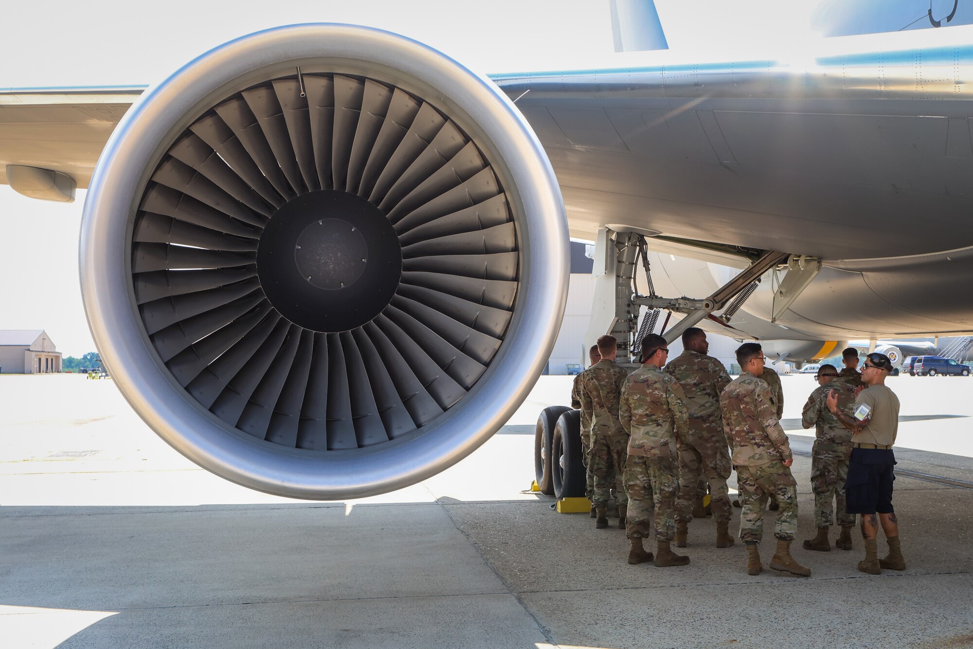 A photo of 177th Logistics Readiness Squadron petroleum, oils and lubricants fuel management flight technicians standing under a KC-64A Pegasus on the flight line of Joint Base McGuire-Dix-Lakehurst.