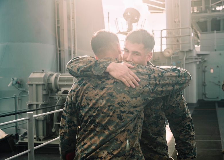 U.S. Marine Corps Gunnery Sgt. Joseph Morelli, right, the communications maintenance chief assigned to the 15th Marine Expeditionary Unit, hugs Sgt. Albert Morelli, an assistant patrol leader assigned to Bravo Company, Battalion Landing Team 1/5, 15th MEU, following Sgt. Morelli’s promotion ceremony aboard the amphibious assault ship USS Boxer (LHD 4) in the Pacific Ocean Aug. 1, 2024.