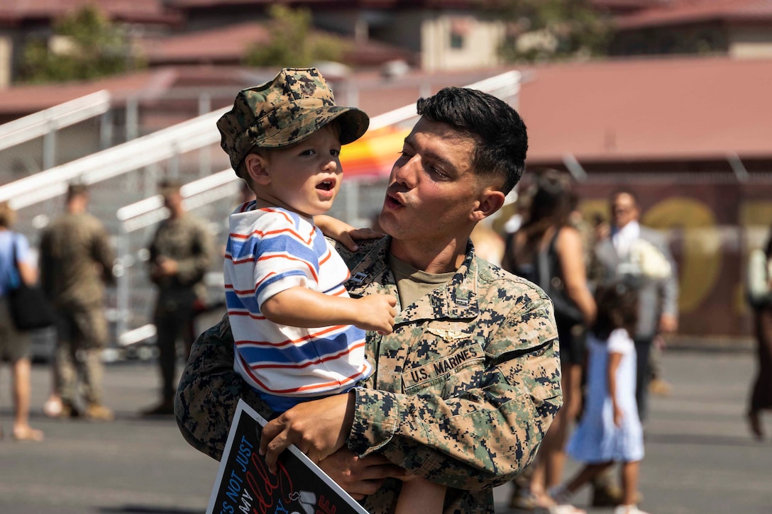 U.S. Marine Corps Capt. Ruben Pickering, a forward air controller with Charlie Company, Battalion Landing Team 1/5, 15th Marine Expeditionary Unit, and a native of Costa Rica, is welcomed by his son after returning from a routine deployment at Marine Corps Base Camp Pendleton, California, Aug. 10, 2024. Elements of the 15th Marine Expeditionary Unit, embarked aboard amphibious transport dock USS Somerset (LPD 25), returned to Marine Corps Base Camp Pendleton after a seven-month deployment to the Indo-Pacific region in support of regional stability and a free and open Indo-Pacific. (U.S. Marine Corps photo by Sgt. Bryant Rodriguez)