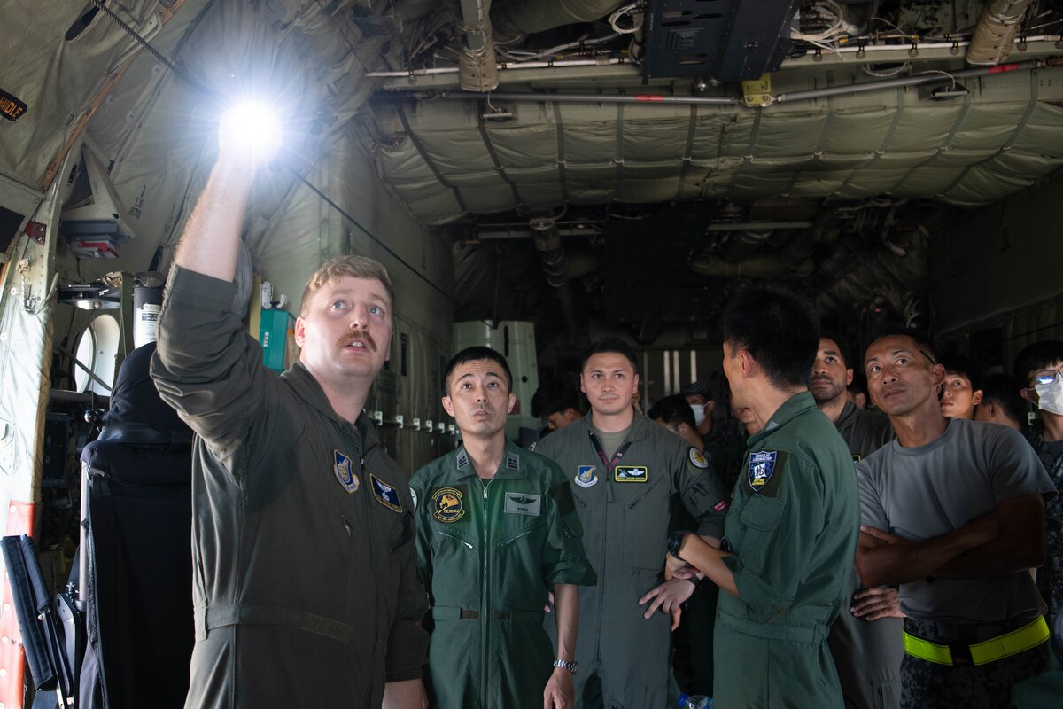 U.S. Air Force Staff Sgt. Trevor Humes, 36th Airlift Squadron instructor loadmaster, conducts a tour of a C-130J Super Hercules.