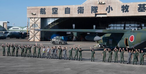 Japan Air Self-Defense Force members of the 401st Tactical Airlift Squadron wave goodbye to U.S. Air Force Airmen of the 36th Airlift Squadron.