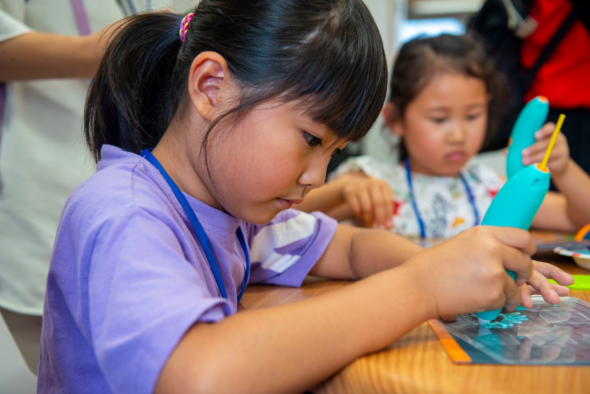 A young participant focuses on their 3D art while touring the Overstreet Library during a Misawa Friendship Tour at Misawa Air Base, Japan, Aug. 2, 2024.