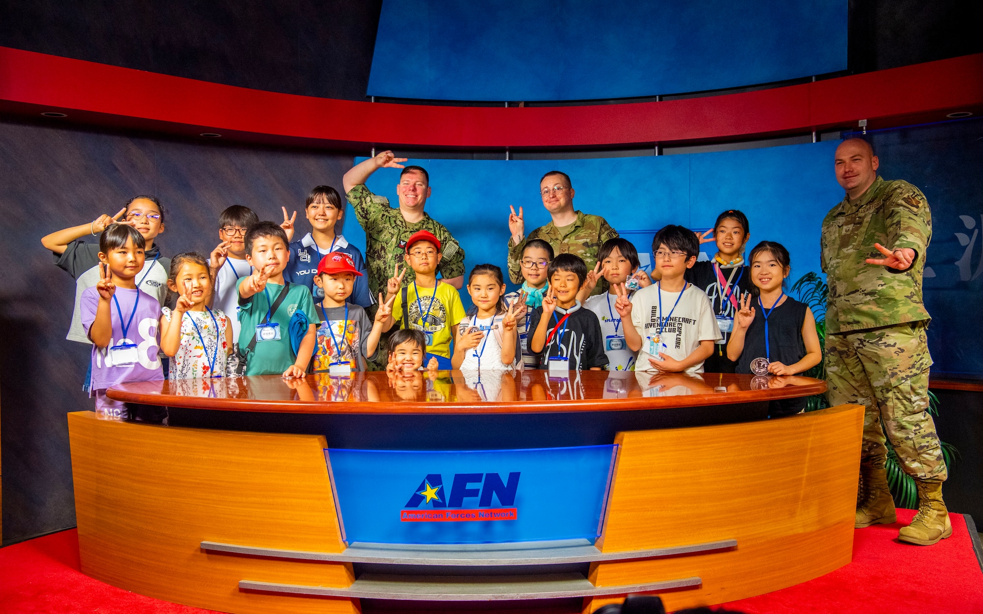 U.S. military members assigned to the American Forces Network pose with Misawa Friendship Tour participants at Misawa Air Base, Japan, Aug. 2, 2024.