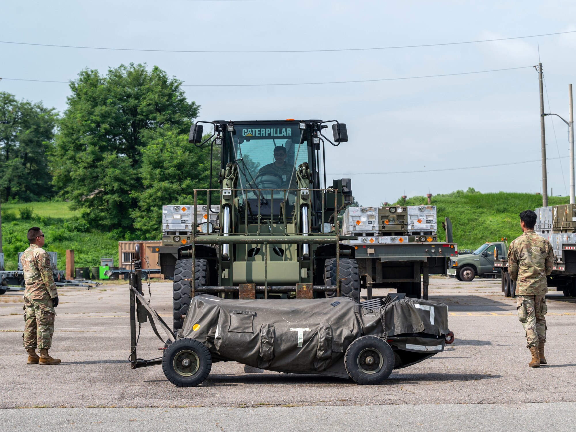 U.S. Air Force Airmen assigned to the 51st Logistics Readiness Squadron, prepare to load cargo onto a forklift during a training event at Osan Air Base, Republic of Korea, Aug. 8, 2024. The 51st LRS operated a forklift to transfer various cargo, expanding their multifunctional abilities needed to carry out the “Fight Tonight” mission. (U.S. Air Force photo by Senior Airman Sabrina Fuller-Judd)