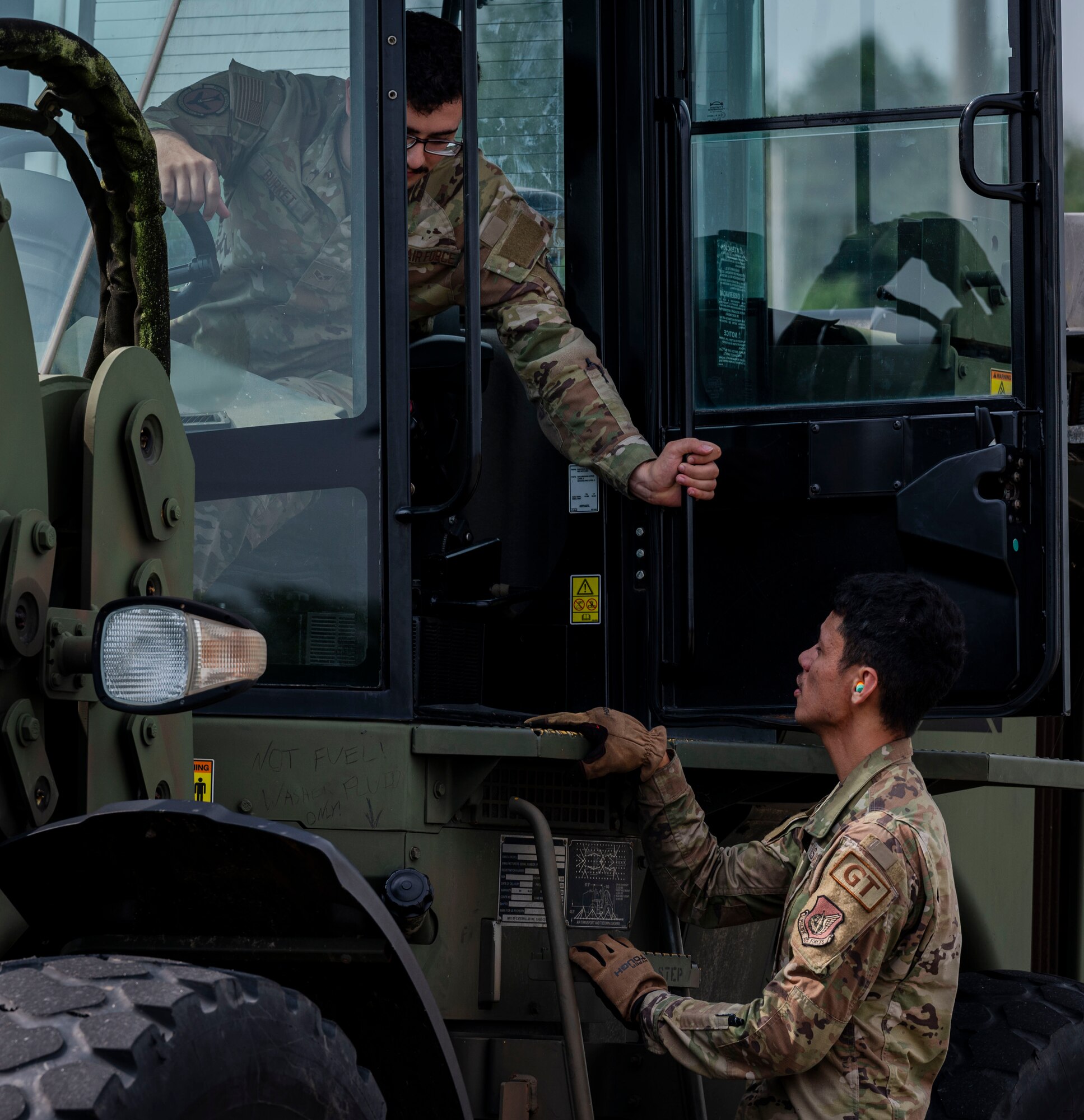 U.S. Air Force Airmen assigned to the 51st Logistics Readiness Squadron discuss plans for loading cargo during a training event at Osan Air Base, Republic of Korea, Aug. 8, 2024. Support from the 51st LRS is critical in sustaining the priorities of the 51st Fighter Wing by remaining responsible for overseeing supply chain management, transportation, fuel logistics and more. (U.S. Air Force photo by Senior Airman Sabrina Fuller-Judd)