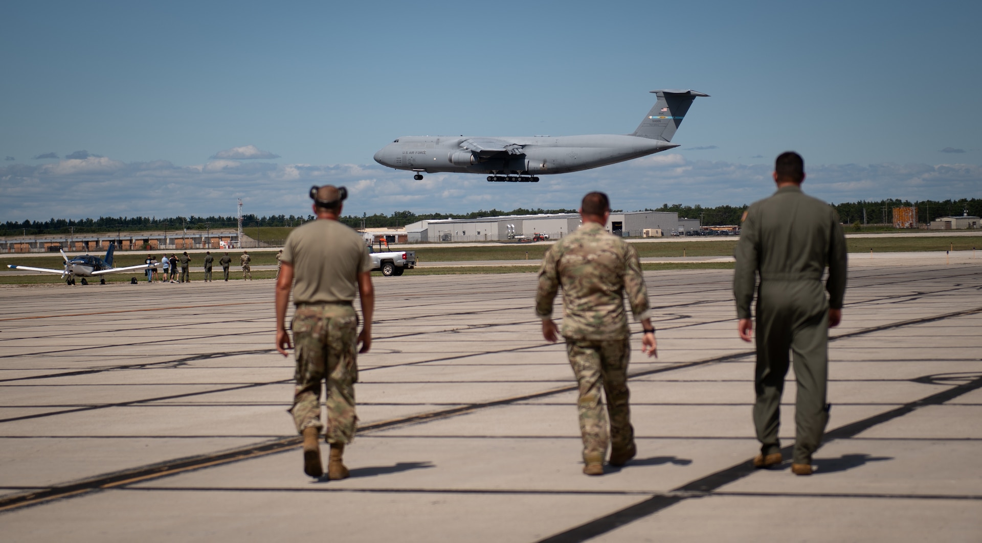 U.S. Air Force members from various Air National Guard units across the country watch as a C-5 Galaxy lands for a wet-wing defuel during Exercise Northern Strike 24-2 at Camp Grayling, Michigan, Aug. 9, 2024.