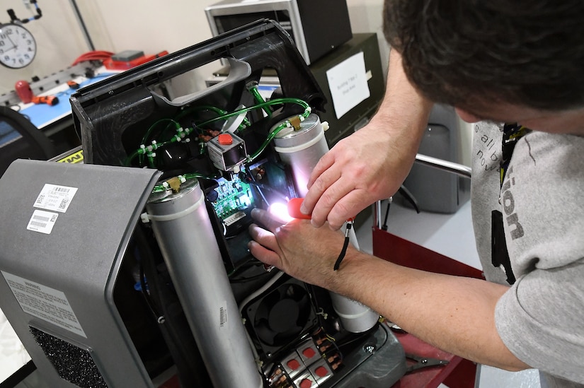 A biomedical equipment technician inspects a medical device at the U.S. Army Medical Materiel Agency’s Medical Maintenance Operations Division at Tobyhanna Army Depot, Pennsylvania, on May 2, 2024. (C.J. Lovelace)