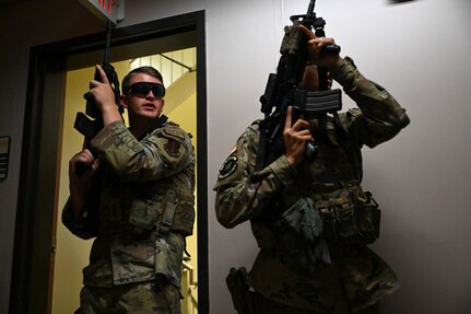 Senior Airman Ben Hathaway, left, and Staff Sgt. Cierra Kelly, Defenders with the 157th Security Forces Squadron, enter a hallway as part of close-quarters battle training in Portsmouth, New Hampshire, Aug. 4, 2024. The training was part of a five-day course created by the 157th Air Refueling Wing as a cost-effective way to elevate the skills of base Defenders.