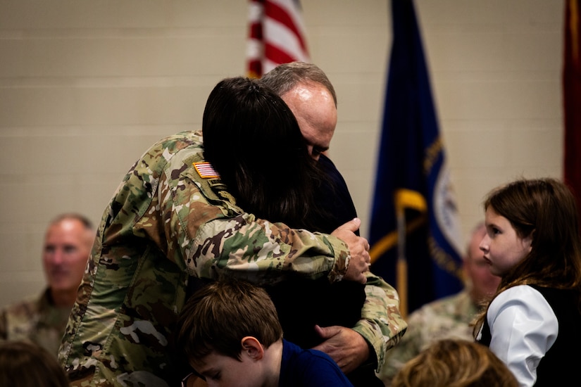 U.S. Army Lt. Col. John Ritchie, the commander of the 613th Engineer Facilities Detachment, 149th Maneuver Enhancement Brigade, hugs his wife at the Springfield Army National Guard Armory in Springfield, Kentucky on August 5, 2024. Approximately 15 Soldiers of the 613 FACDET are departing for Kuwait for base directorate of public works mission at Camp Buehring. (U.S. Army National Guard photo by Andy Dickson)