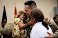 Sgt. 1st Class Cory Valdivieso, an engieer with the 613th Engineer Facilities Detachment, 149th Maneuver Enhancement Brigade, hugs his family at the Springfield Army National Guard Armory in Springfield, Kentucky on August 5, 2024. Approximately 15 Soldiers of the 613 FACDET are departing for Kuwait for base directorate of public works mission at Camp Buehring. (U.S. Army National Guard photo by Andy Dickson)