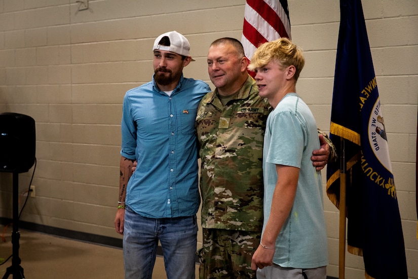 U.S. Army Maj. Charles Hilpp, an engineer officer with the  613th Engineer Facilities Detachment, 149th Maneuver Enhancement Brigade, pose for photos with his family and friends at the Springfield Army National Guard Armory in Springfield, Kentucky on August 5, 2024. Approximately 15 Soldiers of the 613 FACDET are departing for Kuwait for base directorate of public works mission at Camp Buehring. (U.S. Army National Guard photo by Andy Dickson)