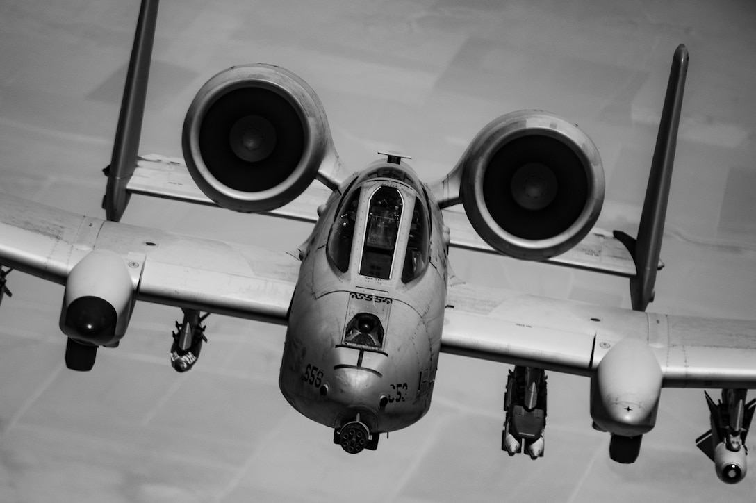 Black and white photo of a military aircraft in flight.