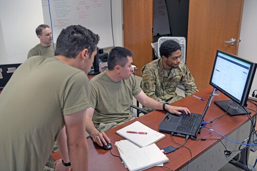 Airmen working at computer