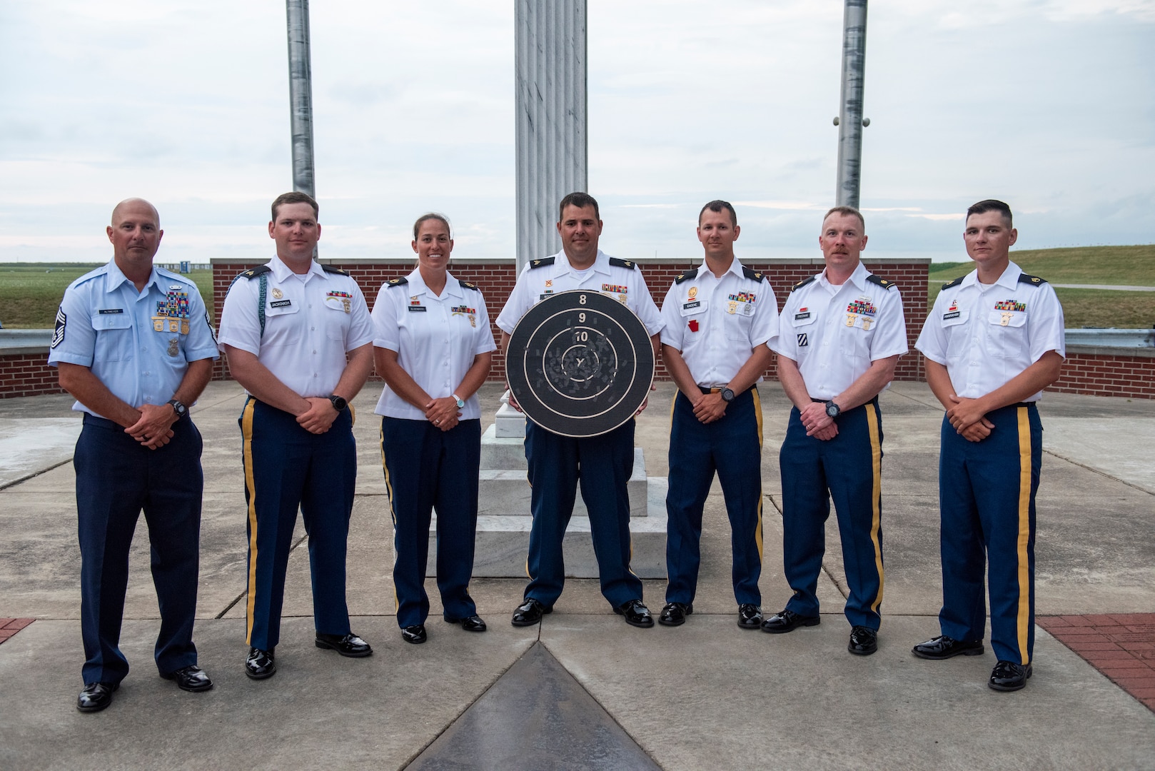 The All National Guard Rifle Team poses with the target they struck from 600 yards after winning the National Trophy, also known as the Dogs of War Trophy, and the Hilton Trophy during the National Matches at Camp Perry, Ohio, Aug. 2, 2024. This is the third time the National Guard won the National Trophy since its inception in 1903.