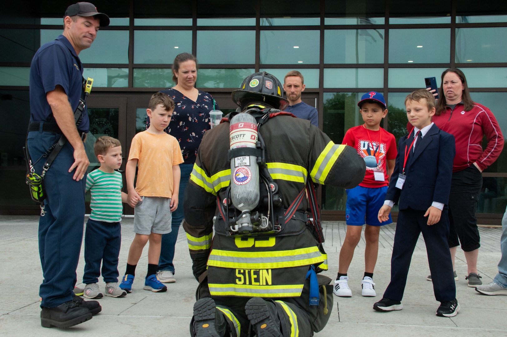 Firefighter talks to kids.