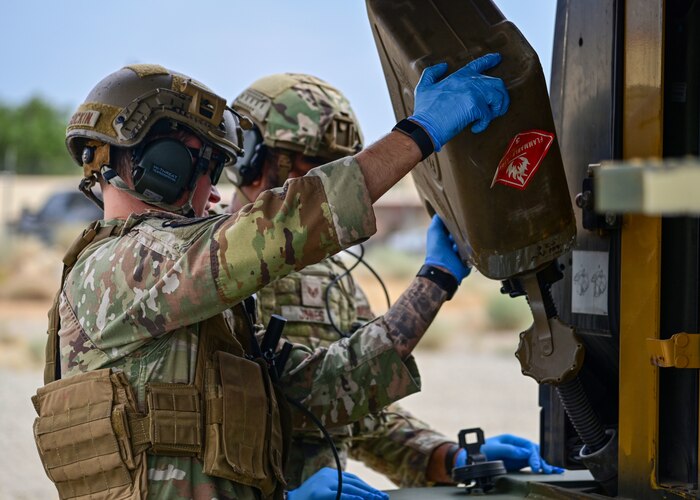 Airmen fueling forklift