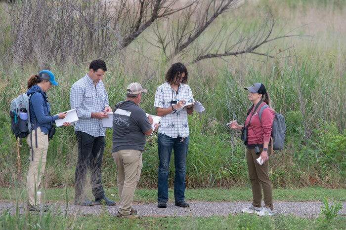 people stand and conduct a survey