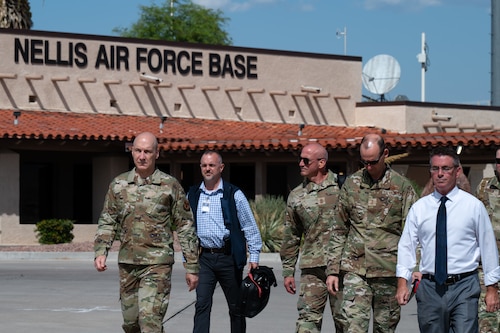 U.S. Air Force Chief of Staff Gen. David Allvin, Chief Master Sergeant of the Air Force David Flosi, and Maj. Gen. Christopher Niemi, the U.S. Air Force Warfare Center commander, walk on the flightline in preparation for a flight during Bamboo Eagle 24-3 at Nellis Air Force Base, Nevada, Aug. 5, 2024. Using designated air space, BE 24-3 provides Airmen, allies and partners a flexible, combat-representative, multidimensional battlespace to conduct testing, tactics development, and advanced training in support of U.S. national interests. (U.S. Air Force photo by Airman 1st Class Brianna Vetro) (This photo has been altered for security purposes by blurring a badge.)
