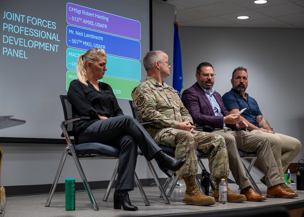 panel members speaks from stage