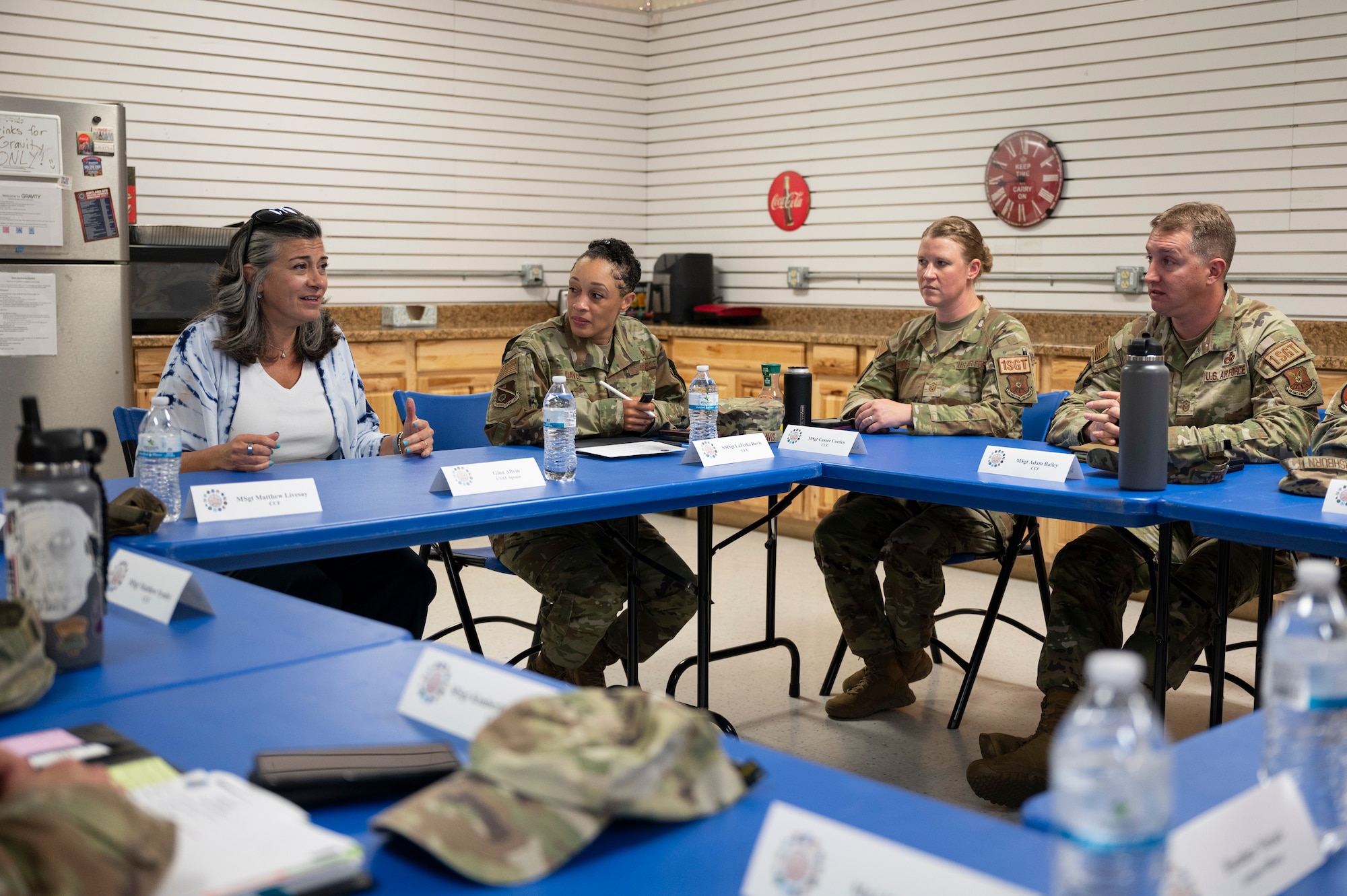 A woman speaks with a group.