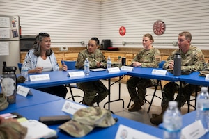 A woman speaks with a group.