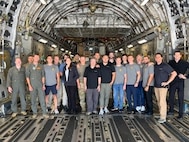people pose on aircraft