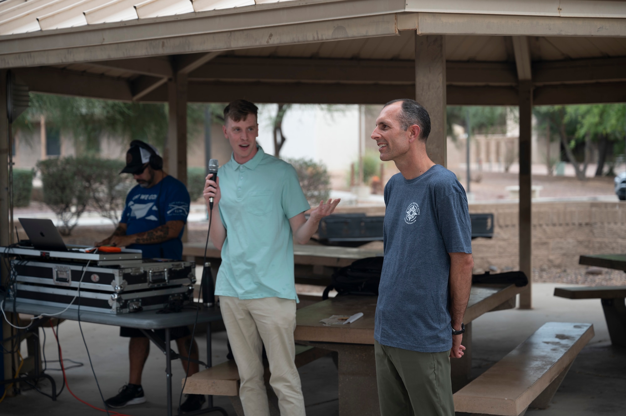 U.S. Airman 1st Class Robert Cooke, Dorm Council President, introduces Col. Gabriel Brown, 355th Wing Deputy Commander, during the Summer Dorm Bash at Davis-Monthan Air Force Base, Ariz., Aug. 9, 2024. Brown provided opening remarks for the Dorm Bash before kicking off the games. (U.S. Air Force photo by Airman 1st Class William Finn V)