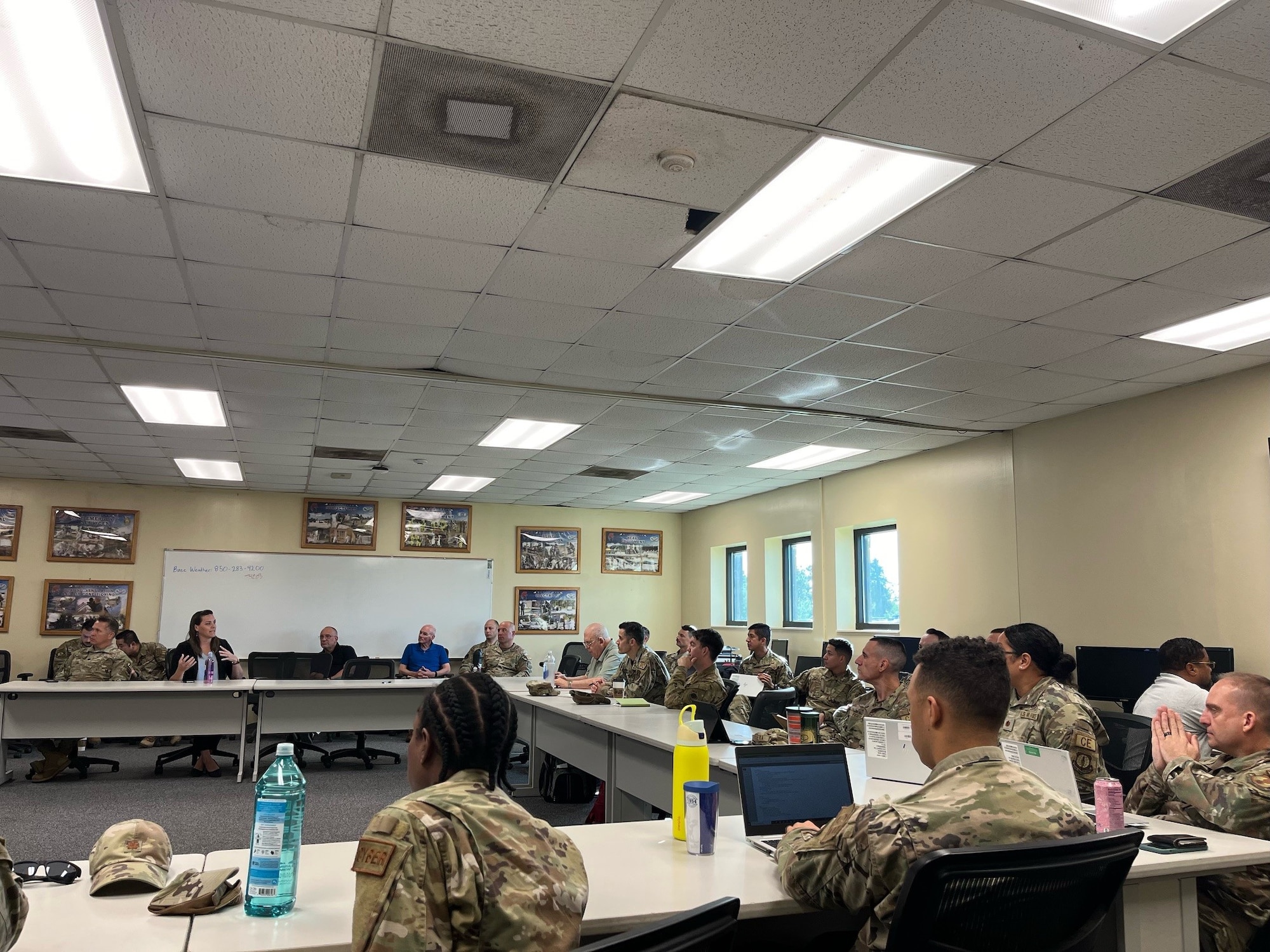 Members from the 12th Air Task Force A-Staff sit at a table at a workshop focused on the development of Combat Support Training Ranges