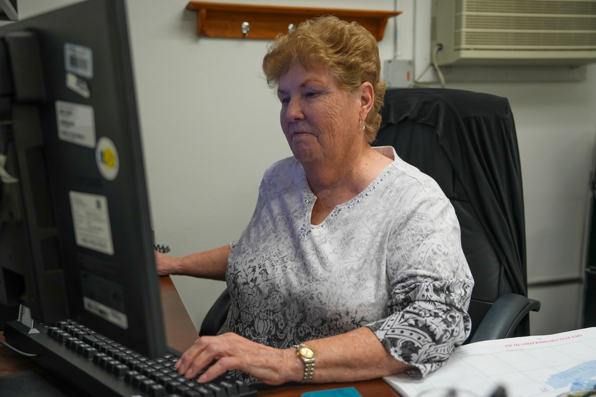A woman works at her computer.