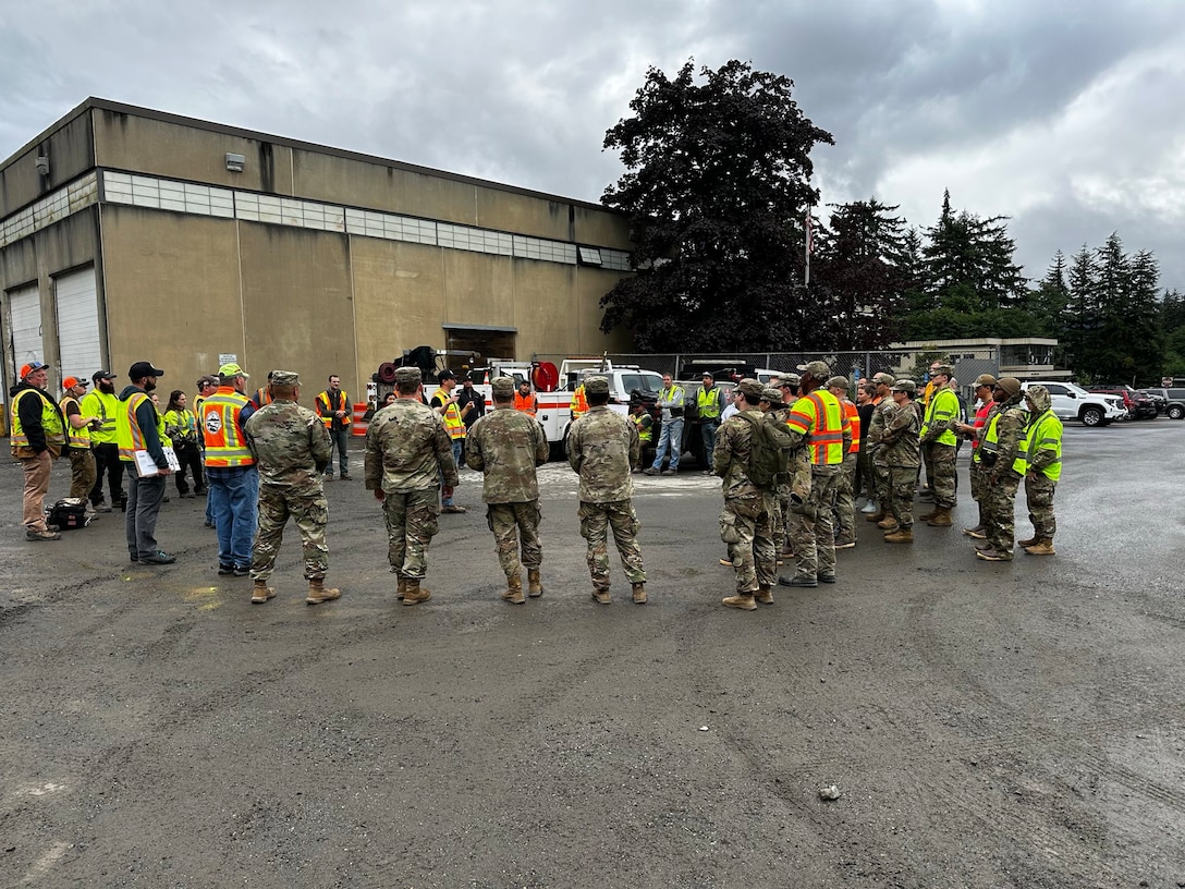 Alaska Army Guardsmen with Joint Task Force – Juneau meet with Department of Transportation personnel prior to assisting Juneau residents with recovery and cleanup efforts Aug. 10, 2024, following recent flooding after the Mendenhall Glacier’s Suicide Basin released.