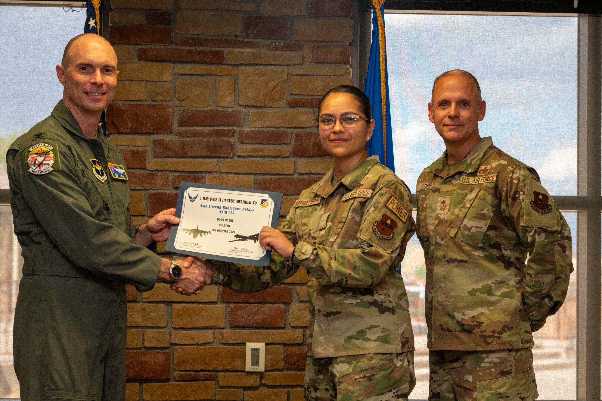 U.S. Air Force Airman Jimena Rodriguez-Pelayo from the Civil Engineer Squadron, accepts the Dorm room of the 2nd Quarter award during the 49th Wing’s 2nd Quarter Award ceremony at Holloman Air Force Base, New Mexico, Aug. 9, 2024. Quarterly award winners were selected based on their technical expertise, demonstration of leadership and job performance. (U.S. Air Force photo by Senior Airman Isaiah Pedrazzini)