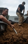 U.S. Air Force Staff Sgt. Paolo DiGirolamo and Senior Airman Dylan Gross, Defense POW/MIA Accounting Agency (DPAA) recovery team members, shovel dirt during a recovery mission in Guadalcanal, Solomon Islands, Aug. 6, 2024.