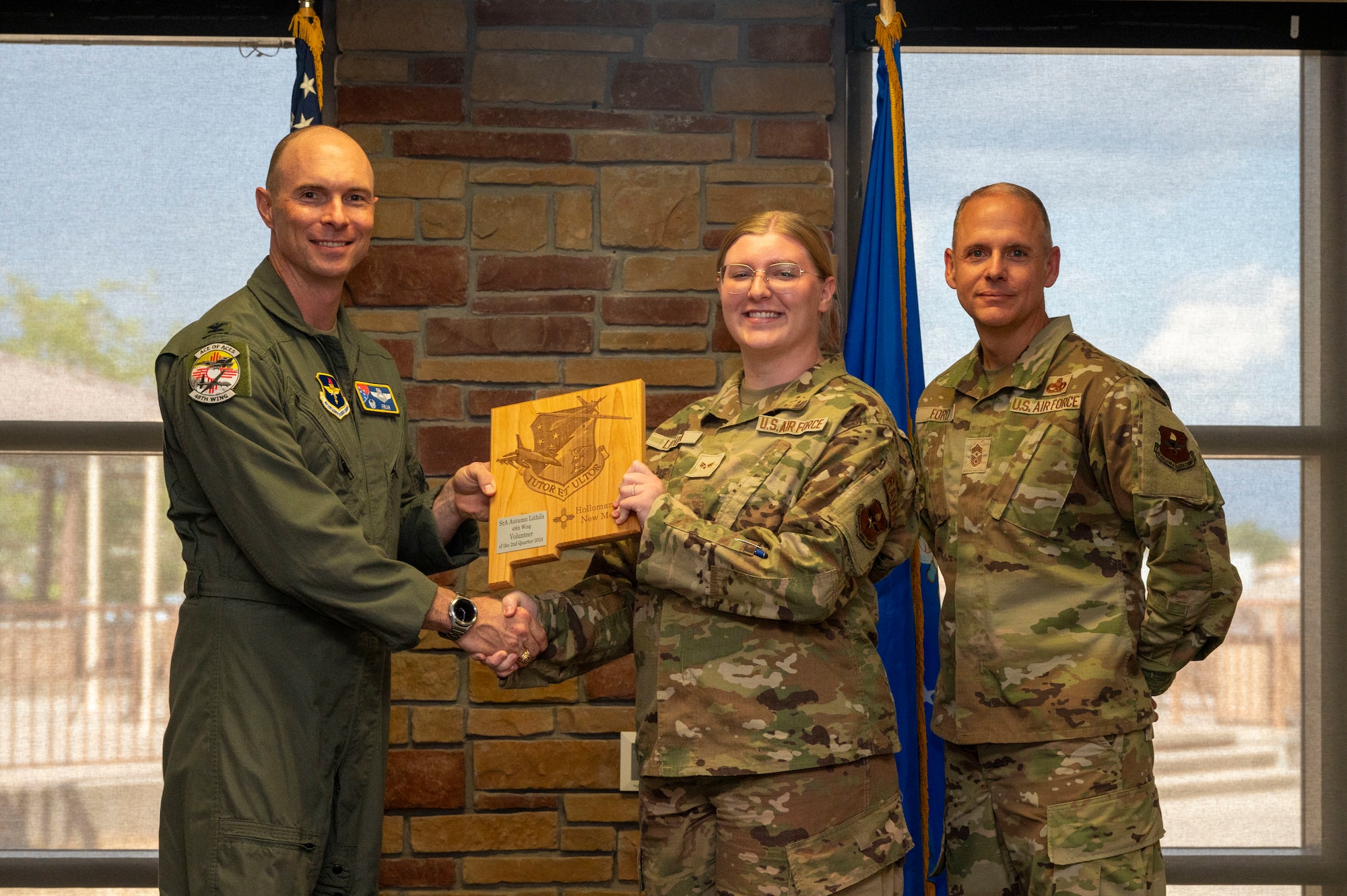 U.S. Air Force Senior Airman Autumn Lithila from the 54th Fighter Group, accepts the Volunteer of the 2nd Quarter award during the 49th Wing’s 2nd Quarter Award ceremony at Holloman Air Force Base, New Mexico, Aug. 9, 2024. Quarterly award winners were selected based on their technical expertise, demonstration of leadership and job performance. (U.S. Air Force photo by Senior Airman Isaiah Pedrazzini)