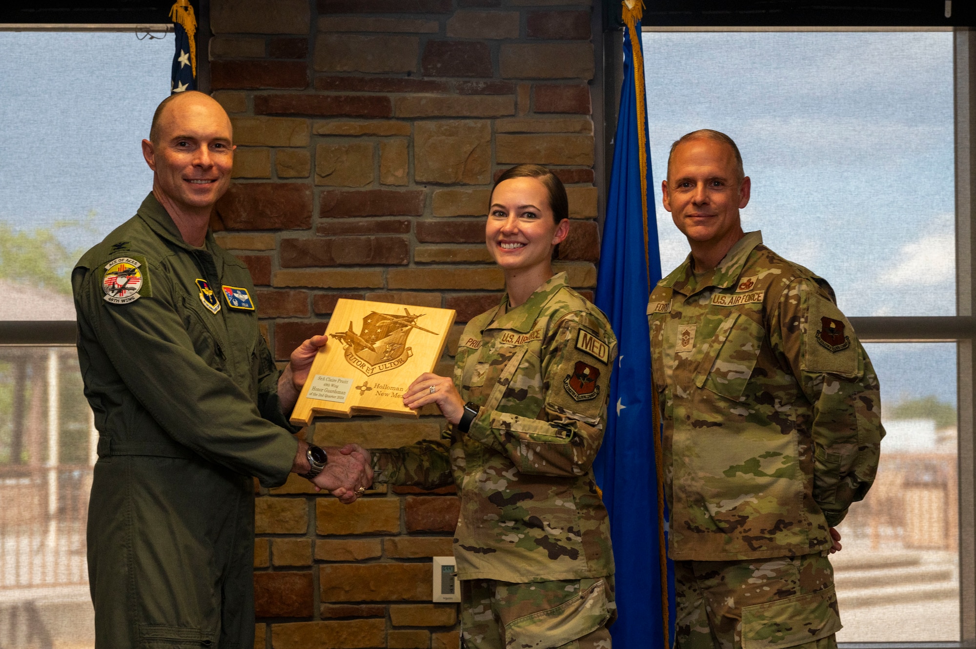 U.S. Air Force Senior Airman Claire Pruitt from the 49th Healthcare Operations Squadron, accepts the Honor Guardsmen of the 2nd Quarter award during the 49th Wing’s 2nd Quarter Award ceremony at Holloman Air Force Base, New Mexico, Aug. 9, 2024. Quarterly award winners were selected based on their technical expertise, demonstration of leadership and job performance. (U.S. Air Force photo by Senior Airman Isaiah Pedrazzini)