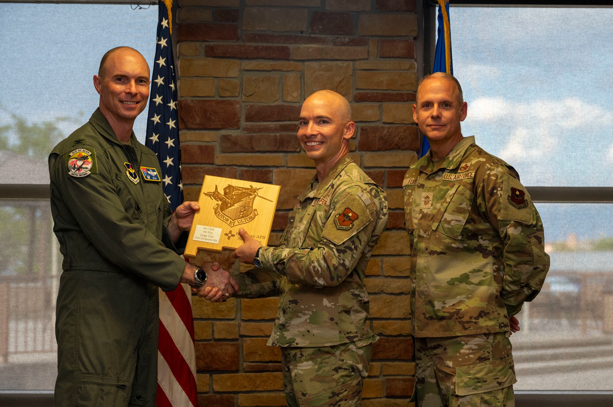 U.S. Air Force Chief Master Sgt. Kyle Eckert, 49th Component Maintenance Squadron senior enlisted leader, accepts the Large Unit of the 2nd Quarter award on behalf of his squadron during the 49th Wing’s 2nd Quarter Award ceremony at Holloman Air Force Base, New Mexico, Aug. 9, 2024. Quarterly award winners were selected based on their technical expertise, demonstration of leadership and job performance. (U.S. Air Force photo by Senior Airman Isaiah Pedrazzini)