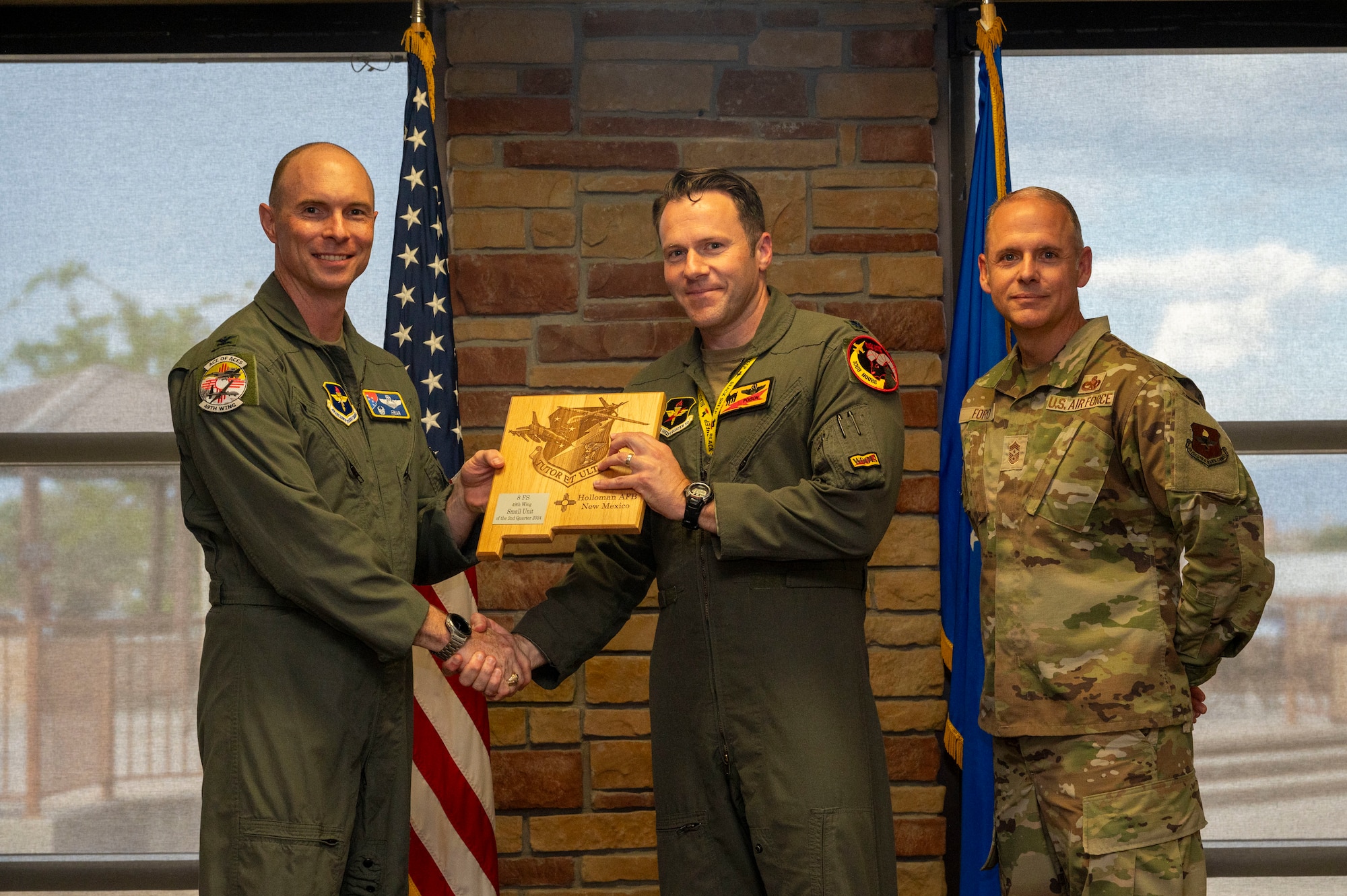 U.S. Air Force Lt. Col. Matthew Marshall, 8th Fighter Squadron commander, accepts the Small Unit of the 2nd Quarter award on behalf of his squadron during the 49th Wing’s 2nd Quarter Award ceremony at Holloman Air Force Base, New Mexico, Aug. 9, 2024. Quarterly award winners were selected based on their technical expertise, demonstration of leadership and job performance. (U.S. Air Force photo by Senior Airman Isaiah Pedrazzini)