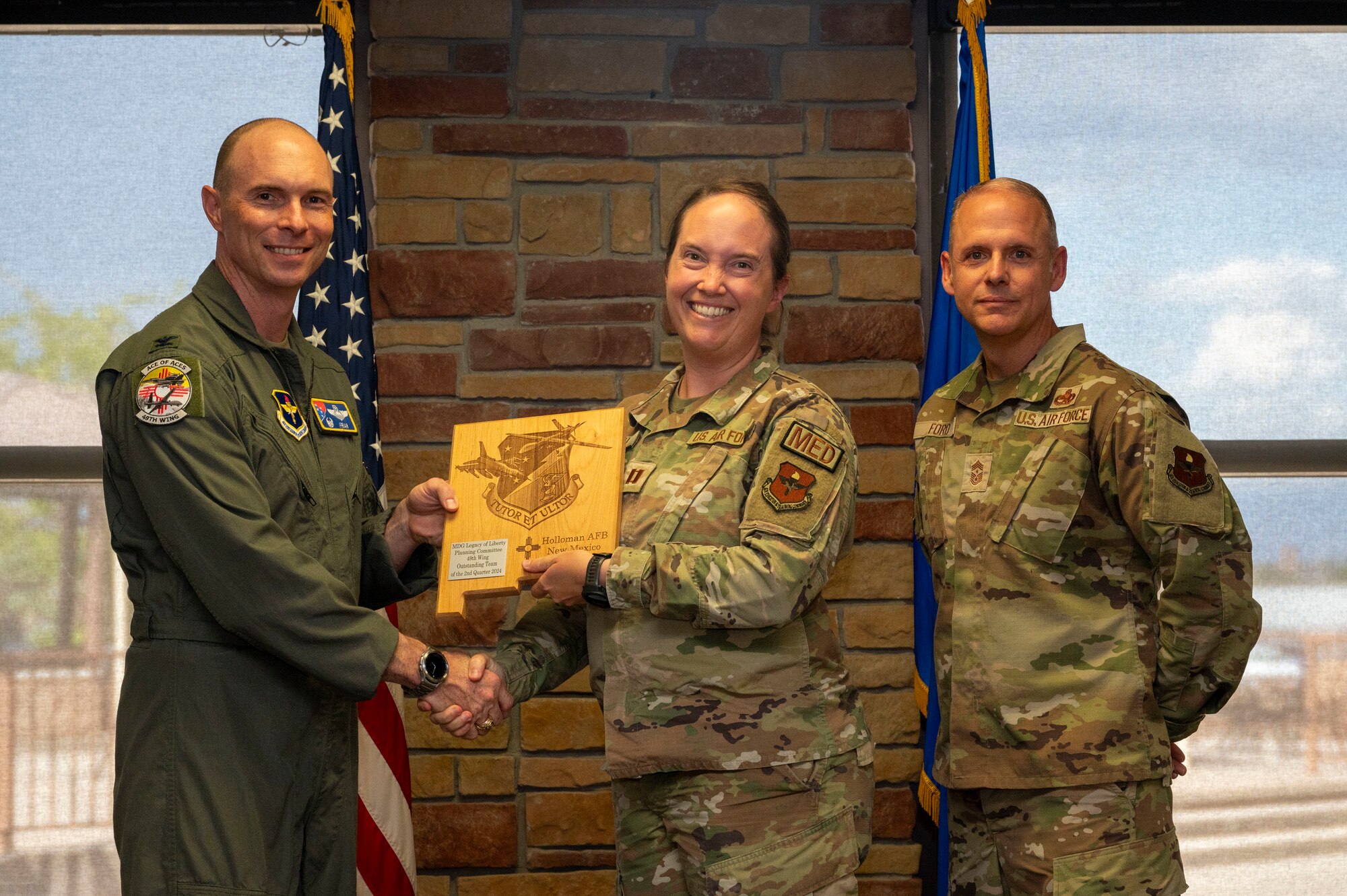 U.S. Air Force Capt. Michaela French from the 49th Medical Group, receives the Outstanding Team of the 2nd Quarter award on behalf of the Legacy of Liberty MDG Planning Committee, during the 49th Wing’s 2nd Quarter Award ceremony at Holloman Air Force Base, New Mexico, Aug. 9, 2024. Quarterly award winners were selected based on their technical expertise, demonstration of leadership and job performance. (U.S. Air Force photo by Senior Airman Isaiah Pedrazzini)