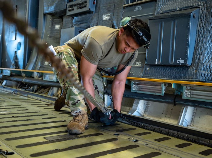 U.S. Air Force Senior Airman Logan Pheng, 709th Airlift Squadron loadmaster, ties down cargo inside a C-5M Super Galaxy at Selfridge Air National Guard Base, Michigan, July 1, 2024. AFWERX, the innovation arm of the U.S. Department of the Air Force and powered by the Air Force Research Laboratory, is advancing cross-training for technical experts through its Traditional Fellowship program and is accepting applications for the next cohort through Aug. 16, 2024. (U.S. Air Force photo/Amanda Jett)