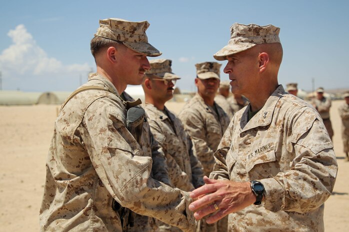 Servicemembers with 1st Battalion, 2d Marine Regiment, 2d MARDIV were awarded a Navy and Marine Corps Commendation Medal for rendering aid to a Marine during a live fire exercise, ultimately saving his life.