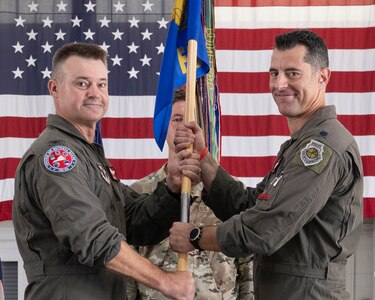 Col. Andrew M. Weidner, left, passes the 149th Fighter Squadron guidon to Lt. Col. Peter “Sly” Liggieri.