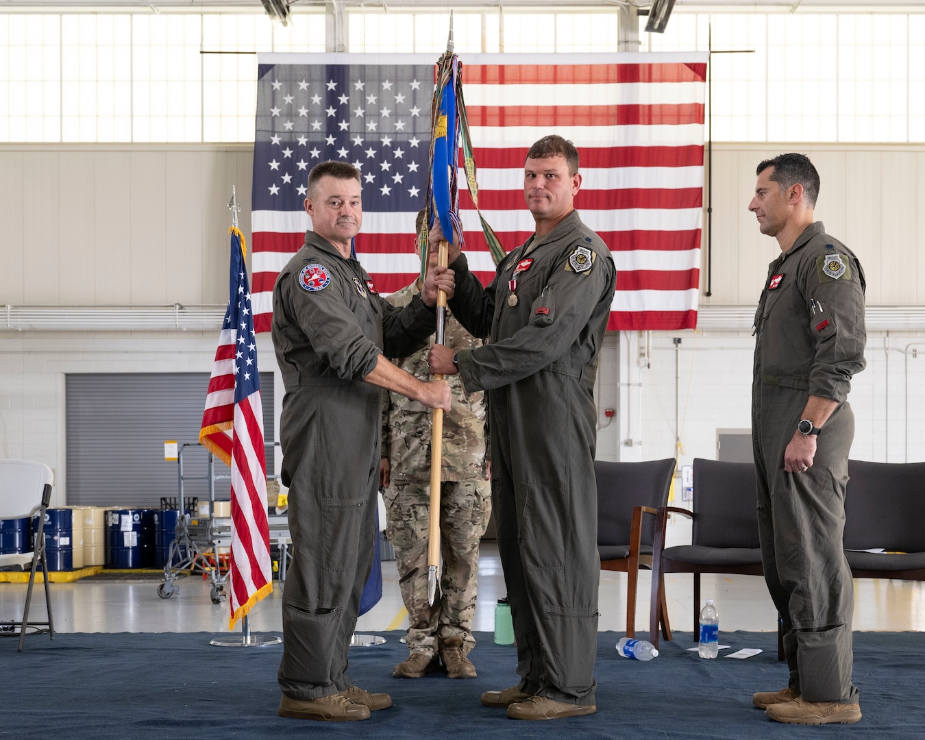 Col. Andrew M. Weidner, left, takes the 149th Fighter Squadron guidon from Lt. Col. Lawrence “Mongo” Dietrich.