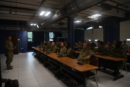 Classroom of Airmen with one speaker on left.