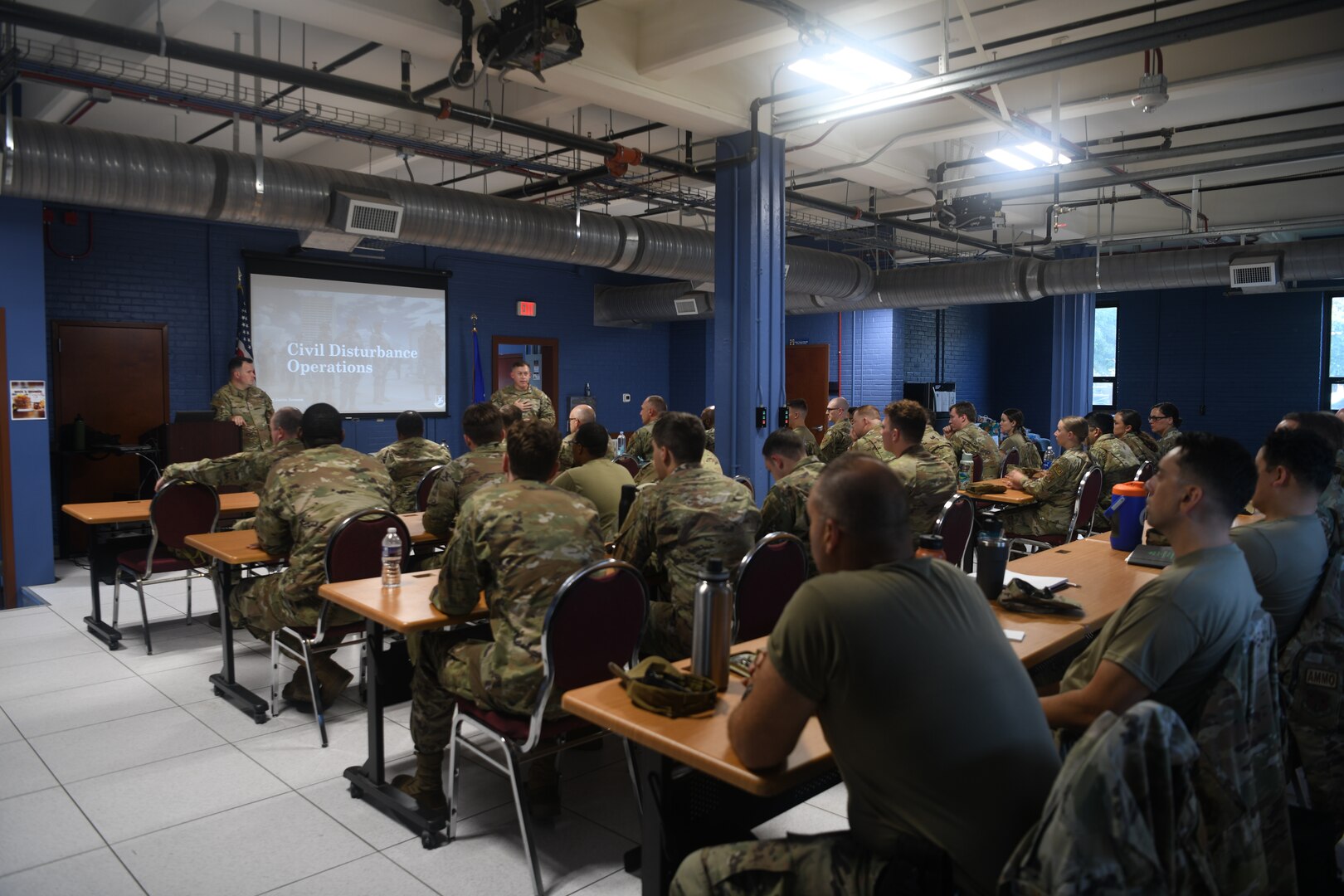 Classroom of Airmen with speaker up front.