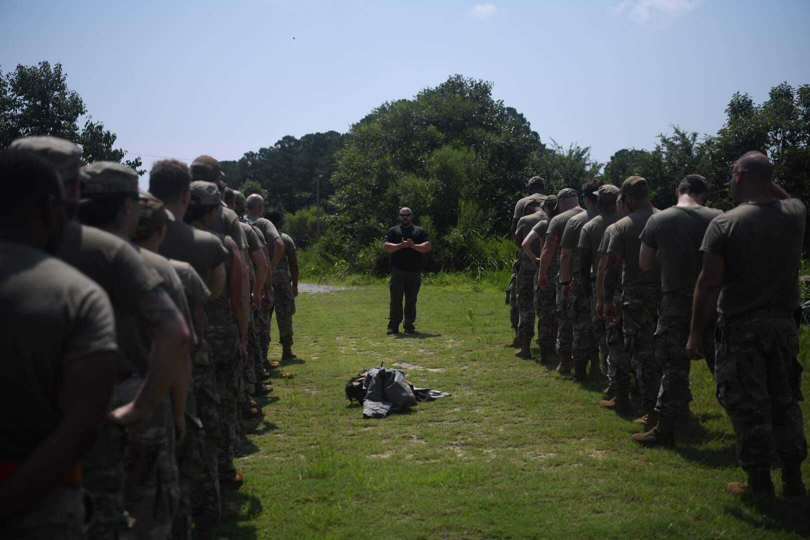 Airmen in two lines listening to police officer instructor.