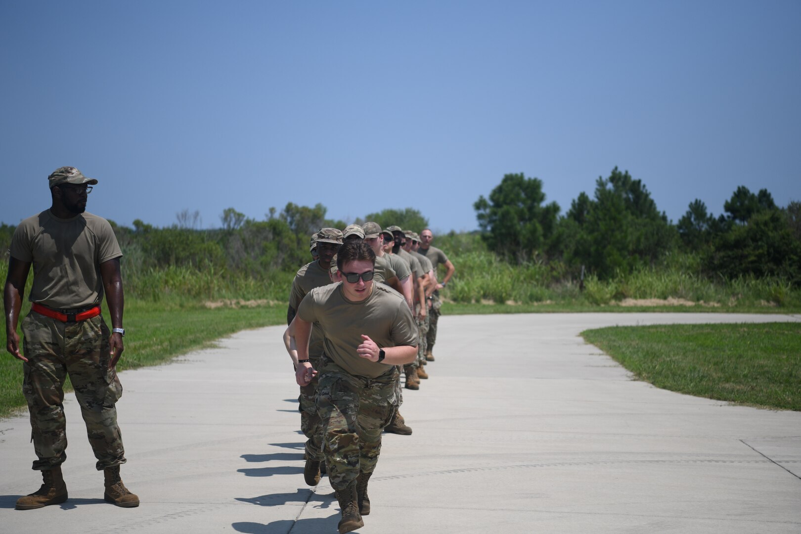 Airmen running in a line.