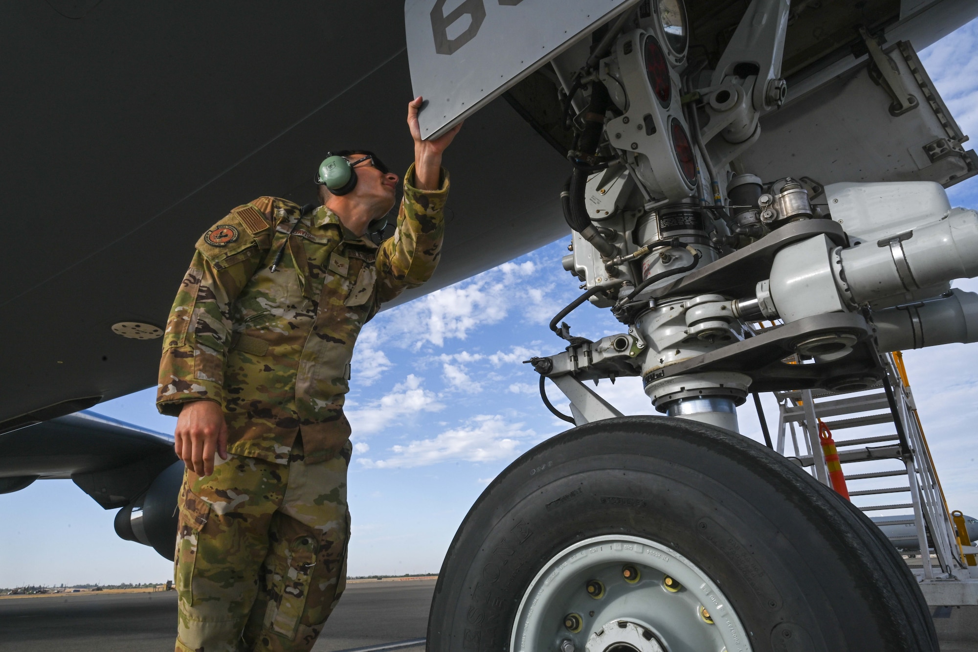 Senior Airman Bridger Davis, 22nd Aircraft Maintenance Squadron flying crew chief, inspects a KC-46 Pegausus before it takes off for Bamboo Eagle 24-3 on Aug. 8, 2024, at Sacramento Mather Airport, California. Air Mobility Command’s AMXS squadrons from different bases jointly provided critical ground support capabilities for the Air Force’s newest tanker by exploding into theater during Bamboo Eagle, a coastal exercise that tests the integration of mobility, combat, bomber, joint and Allied aircraft, which is key to joint force and international partner success. This iteration’s BE 24-3 is an example of how the Air Force implements large-scale exercises and mission-focused training encompassing multiple operational plans to demonstrate and rehearse for complex, large-scale military operations. (U.S. Air Force photo by Senior Airman William Lunn)