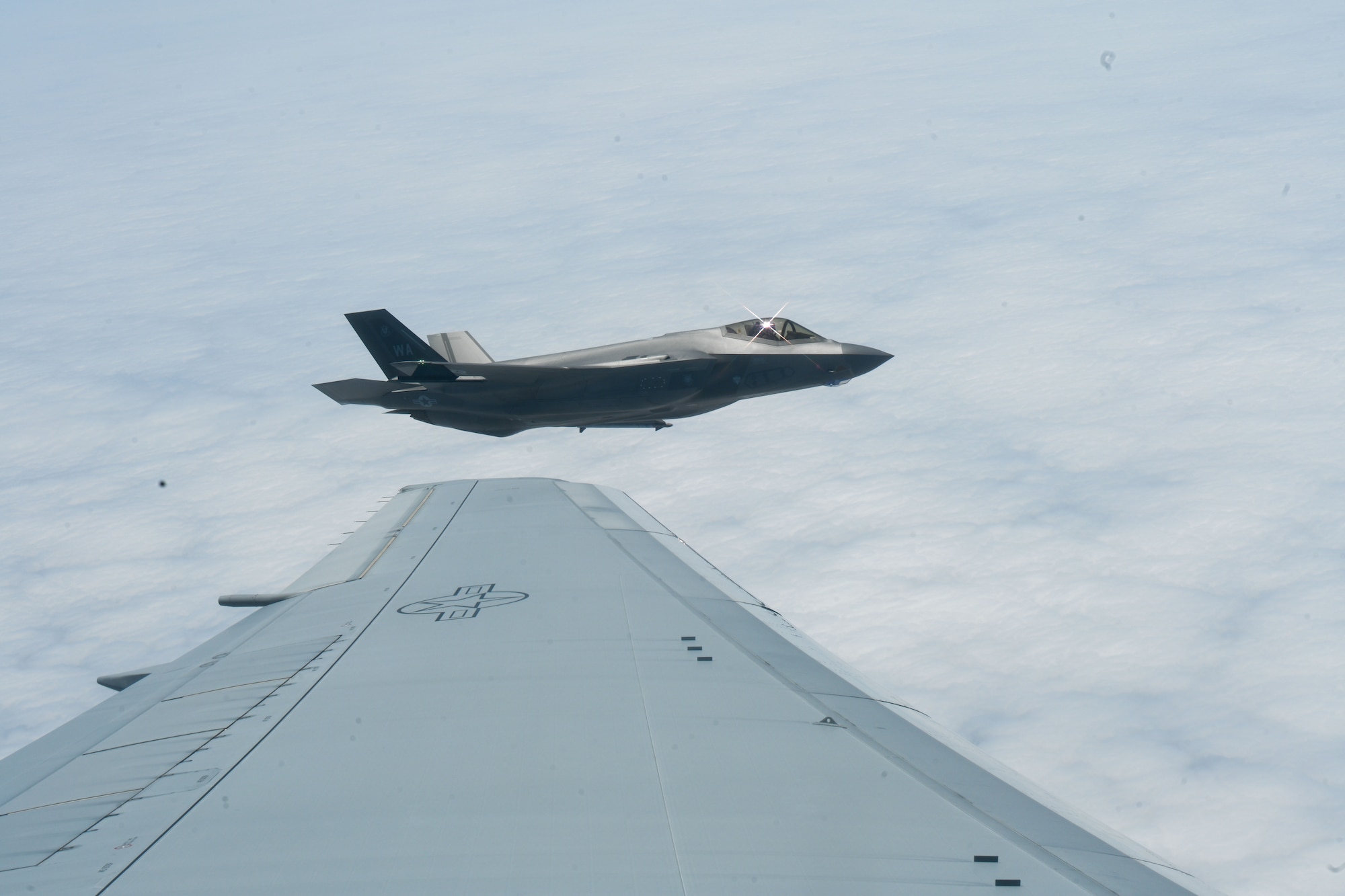 An F-22 Raptor flies in formation before being refueled by a KC-46 Pegasus over the coast of California for Bamboo Eagle 24-3 on Aug. 8, 2024. The KC-46 Pegasus provides critical inflight refueling capabilities for the Air Force, testing its ability to deploy rapidly and maneuver the Joint Force at time, scale and mass. Pilots from the 344th Air Refueling Squadron at McConnell Air Force Base demonstrated their capability to refuel various types of fighter aircraft from different branches during the coastal exercise. Bamboo Eagle tests the integration of mobility, combat, bomber, joint and Allied aircraft, which is key to joint force and international partner success. This iteration’s BE 24-3 is an example of how the Air Force implements large-scale exercises and mission-focused training encompassing multiple operational plans to demonstrate and rehearse for complex, large-scale military operations. (U.S. Air Force photo by Senior Airman William Lunn)