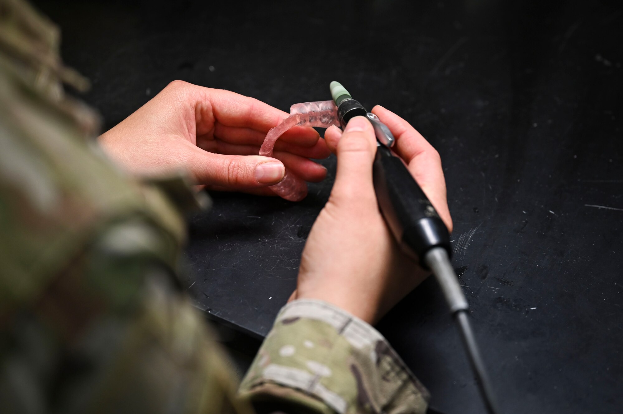 U.S. Air Force Staff Sgt. Sarah Clancy, 8th Operational Medical Readiness Squadron noncommissioned officer in charge of dental lab, polishes a hard night guard at Kunsan Air Base, Republic of Korea.