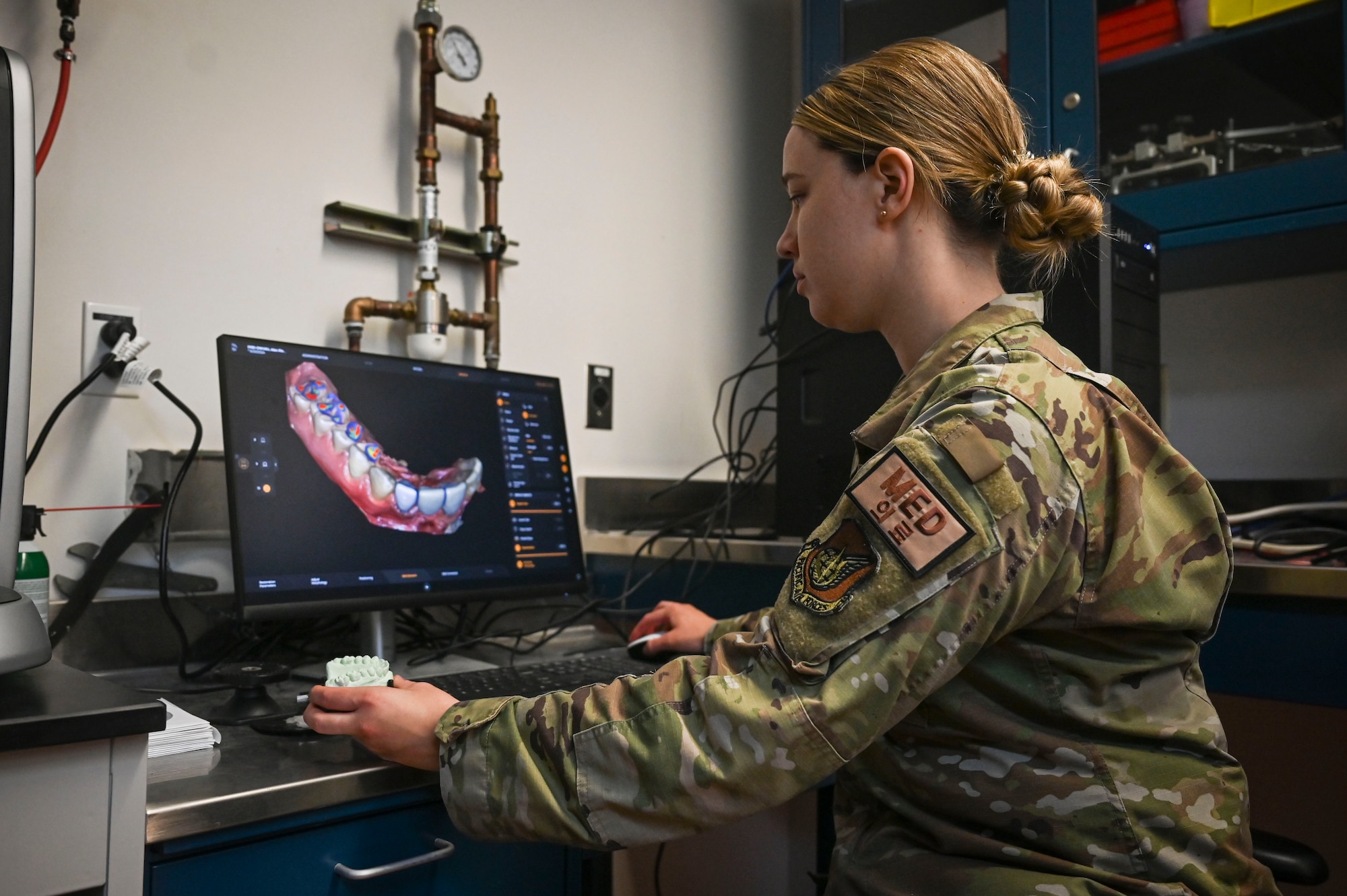 U.S. Air Force Staff Sgt. Sarah Clancy, 8th Operational Medical Readiness Squadron noncommissioned officer in charge of the dental lab, digitally designs and manufactures a tooth at Kunsan Air Base, Republic of Korea.